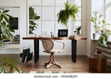 Interior Design Of Home Office Space With Stylish Wooden Desk, Beautiful Chair, Laptop, Platns, Book And Elegant Personal Accesories In Cozy Home Decor.