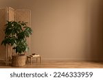 Interior design of living room interior with copy space, partition wall, plant in basket, braided stool, books, beige wall wooden floor and  personal accessories. Home decor. Template. 