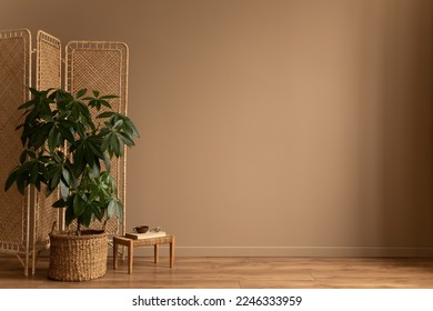 Interior design of living room interior with copy space, partition wall, plant in basket, braided stool, books, beige wall wooden floor and  personal accessories. Home decor. Template.  - Powered by Shutterstock