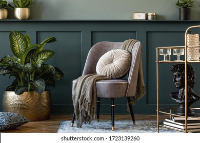 Interior design of luxury living room with stylish armchair, gold liquor cabinet, a lot of plants and elegant personal accessories. Wood panelling with shelf. Modern home decor. Template. 