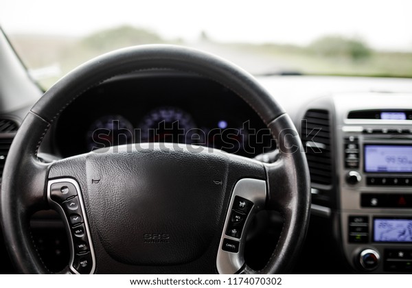 Interior design of the modern\
car. Modern luxury prestige car interior, dashboard, steering\
wheel.