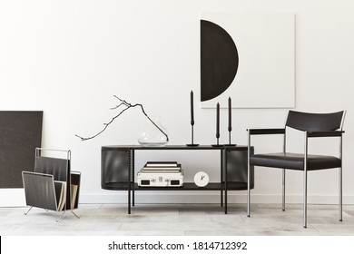 Interior design of modern living room with black stylish commode, chair, mock up art paintings, lamp, book, candlestick, decorations and elegant accessories in home decor. Template.  - Shutterstock ID 1814712392