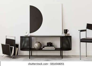 Interior design of modern living room with black stylish commode, chair, mock up art paintings, lamp, book, candlestick, decorations and elegant accessories in home decor. Template. - Shutterstock ID 1816544051
