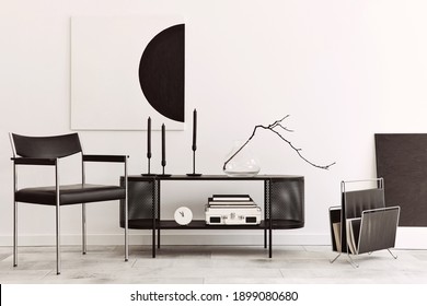Interior design of modern living room with black stylish commode, chair, mock up art paintings, lamp, book, candlestick, decorations and elegant accessories in home decor. Template.  - Shutterstock ID 1899080680