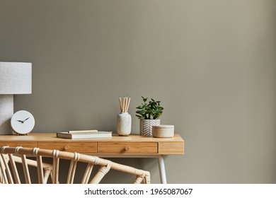 Interior design of neutral bohemian living room interior with stylish desk, armchair, lamp, plant, decoration, office supplies, clock, copy space, notes and personal accessories. Template. 