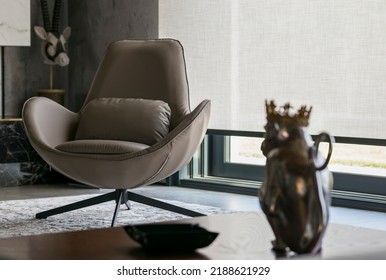 Interior Design With Roller Blinds In The Background. Automatic Solar Shades Of Large Sizes On The Window. Fabric With Linen Texture. In Front Of A Large Window Is A Chair On A Carpet. 