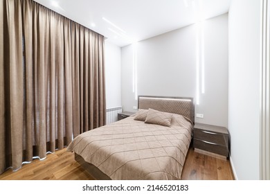 Interior Design Of A Room With A Large Bed And Window. Backlight On The Wall