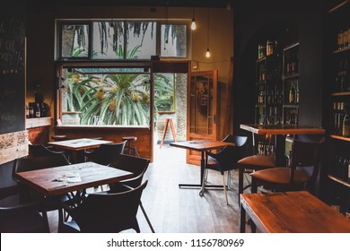 Interior design, the rustic indoor ambiance of an empty bistro bar adorned with wooden elements, tropical window view of palm trees in Swakopmund in Namibia.  - Powered by Shutterstock