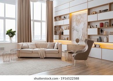 interior design spacious bright studio apartment in Scandinavian style and warm pastel white and beige colors. trendy furniture in the living area and modern details in the kitchen area.