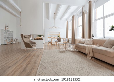 interior design spacious bright studio apartment in Scandinavian style and warm pastel white and beige colors. trendy furniture in the living area and modern details in the kitchen area. - Shutterstock ID 1918121552