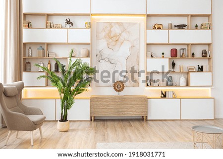 interior design spacious bright studio apartment in Scandinavian style and warm pastel white and beige colors. trendy furniture in the living area and modern details in the kitchen area.