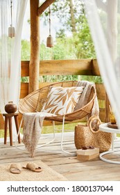 Interior Design Of  Summer Gazebo By The Lake With Stylish Rattan Armchair, Coffee Table, Sofa, Pillows, Plaid And Elegant Accessories In Modern Decor. Summer Vibes.