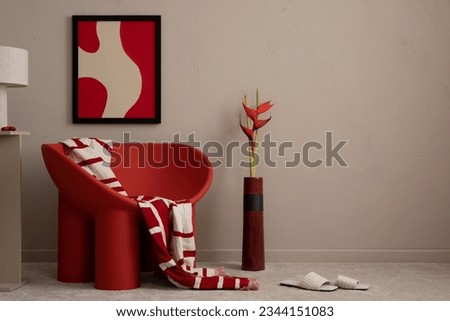 Interior design of warm living room with mock up poster frame, copy space, modern red armchair, patterned plaid, vase with flowers, brown wall and personal accessories. Home decor. Template.