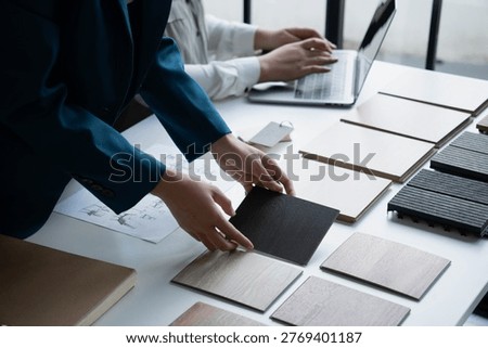 Interior Designer Consulting with Client on Material Selection.