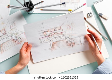 Interior Designer Holding  Pencil Sketch Of A Kitchen In A Process Of Drawing. Interior Design Projects Concept