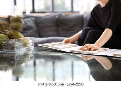 Interior Designer With The Probe Carpets. Woman Chooses Carpet For The Living Room