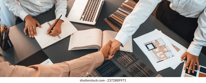 Interior designer shake hand with client or colleagues after made successful sketching and choosing mood board materials or color selection for modern house interior design. Insight - Powered by Shutterstock