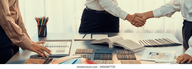 Interior designer shake hand with client or colleagues after made successful sketching and choosing mood board materials or color selection for modern house interior design. Insight - Powered by Shutterstock