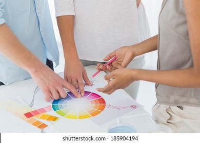 Interior designer showing colour wheel to customers in her studio - Powered by Shutterstock