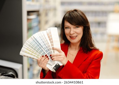 Interior designer smiling while holding a vibrant color palette in a bustling hardware store, exploring options for home improvement projects