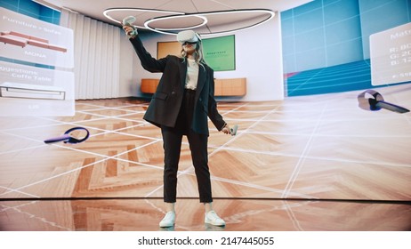 Interior Designer Using a VR Software to Design a Living Space. Change Couch Colors, Move Furniture in Interactive Environment on a Big Digital Screen. Female Engineer Using Headset and Controllers. - Powered by Shutterstock - Get 15% off with code: PIKWIZARD15