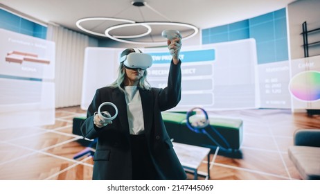 Interior Designer Using a VR Software to Design a Home, Try Different Colors, Move Furniture in Interactive Environment. Female Engineer Using Virtual Reality Headset and Controllers for Her Project. - Powered by Shutterstock