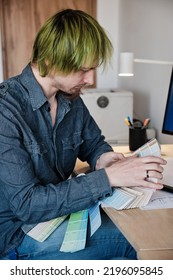 Interior Designer Working In Office With Color Palette. Man With Green Hair.