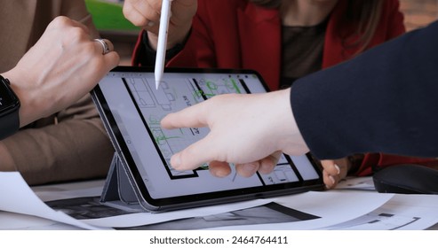 Interior designers using tablet for design, focusing on floor plan details Integrating traditional drafting with digital tools for innovative solutions. Collaborative work office, boosting creativity - Powered by Shutterstock