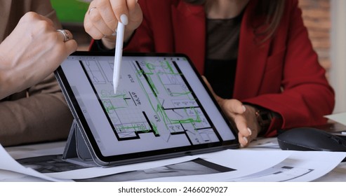 Interior designers using tablet for design, focusing on floor plan details Integrating traditional drafting with digital tools for innovative solutions. Collaborative work office, boosting creativity - Powered by Shutterstock - Get 15% off with code: PIKWIZARD15