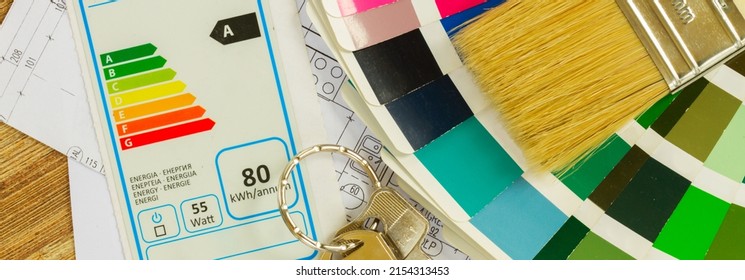 Interior Designer's Working Desktop With Energy Rating Chart, Architectural Plan Of The House, Color Palette And Brushes