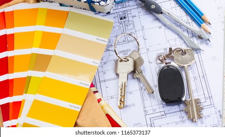 Interior Designer's Working Table, An Architectural Plan Of The House, Color Palette Guide And Fabric Samples In Yellow Shades