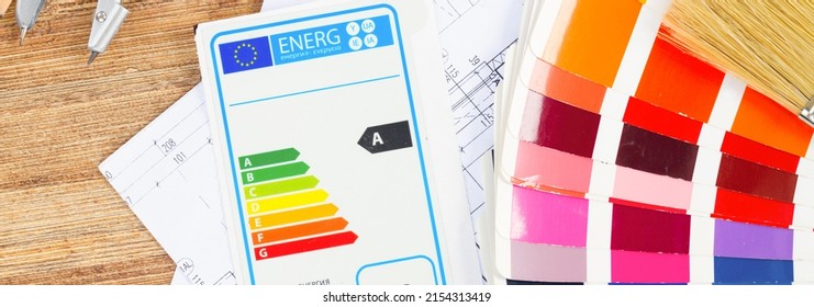 Interior Designer's Working Table With Energy Rating Chart, Architectural Plan Of The House, Color Palette And Brushes