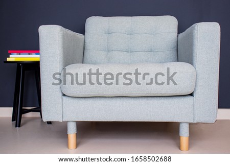 interior design,light gray sofa with books on dark wall. waitingroom seat