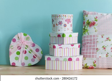 Interior Detail. Home Shelf With Shabby Chic Gift Boxes And Pillow On It Over Blue Wall