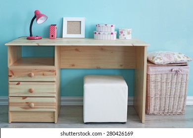 Interior Detail. Study Table And Decor For Kid Girl In Bedroom Over Blue Wall