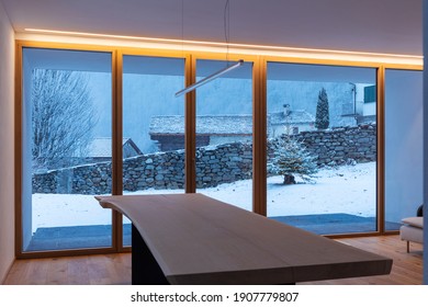 Interior Of A Dining Room, With A Large Bay Window, No One Inside And Outside There Is Snow