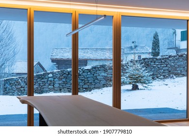 Interior Of A Dining Room, With A Large Bay Window, No One Inside And Outside There Is Snow