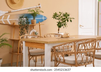 Interior of dining room with table and surfboard