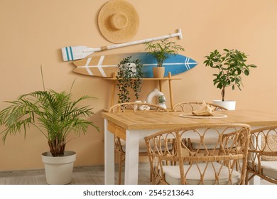 Interior of dining room with table and surfboard