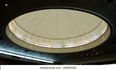 An Interior Dome Ceiling With Lightings In A Conference Room