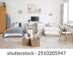 Interior of dorm room with beds, tables and moving boxes