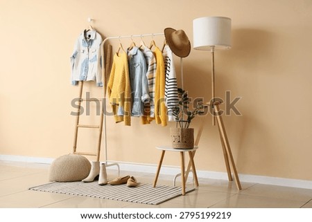 Interior of dressing room with clothes rack, ladder and lamp