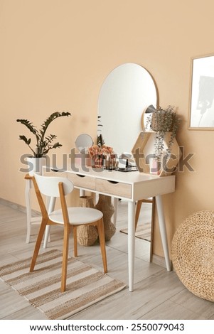 Interior of dressing room with makeup table, mirror and plants