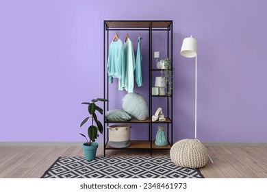 Interior of dressing room with shelving unit, clothes and lamp - Shutterstock ID 2348461973