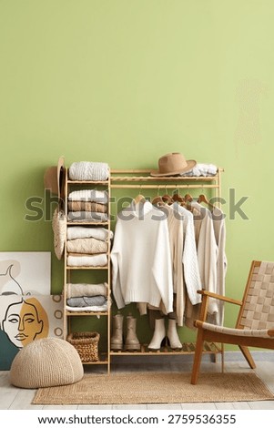 Interior of dressing room with warm sweaters and armchair