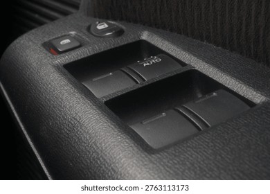 The interior driver's side door panel switches for a Honda Freed.