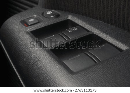The interior driver's side door panel switches for a Honda Freed.
