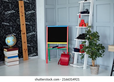 Interior Of Elementary School. Chalkboard, Books, Globe, Red Backpack, Pencils And Stationery In Classroom. Back To School. Classroom With Blackboard. Kindergarten. Interior Of Children's Room