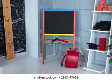 Interior Of Elementary School. Chalkboard, Red Backpack, Pencils And Stationery On Classroom. Teachers Day. Back To School. Empty Classroom With Blackboard. Kindergarten. Interior Of Children's Room
