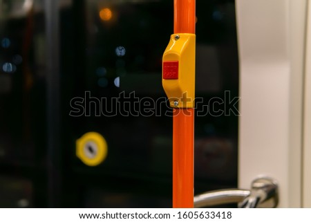 interior elements of public transport - button to signal the driver to stop - on a blurred background